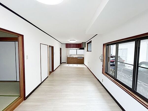 【リフォーム済み】LDKからキッチンを見た写真です。床のカーペット撤去し、クッションフロアに張替えを行いました。壁はクロスに張替えました。
