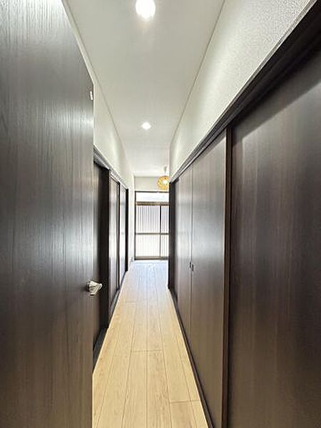 【リフォーム済】廊下の写真です。シンプルで落ち着いたデザインに仕上げました。照明や建具は交換しました。