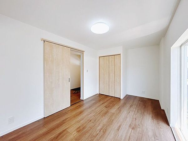 【リフォーム済】1階東側約6.5帖の洋室別アングルです。フロア仕上げ、壁天井クロス張替、照明器具交換、火災報知器設置、TVジャック設置、エアコンコンセント設置を行いました。