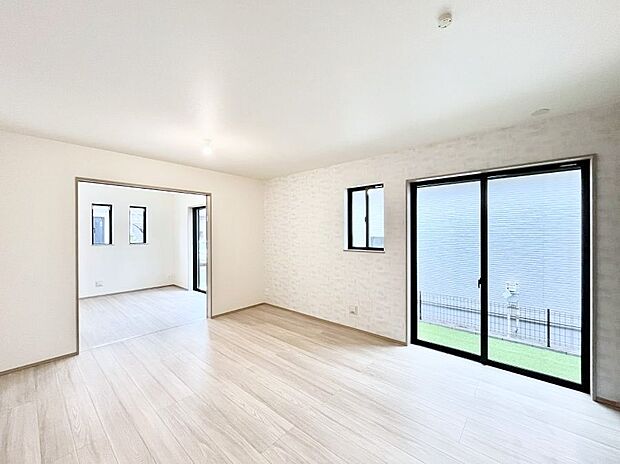 明るい陽光が注ぎ、寛ぎの雰囲気に満たされるリビング・ダイニング。 