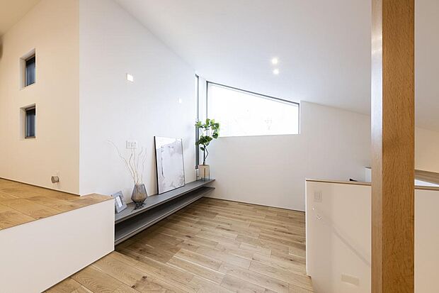 中２階にあるリビング。南面の台形窓から明るい光がたっぷり入ります。グレーの造作家具のTVボードがポイントになっています。