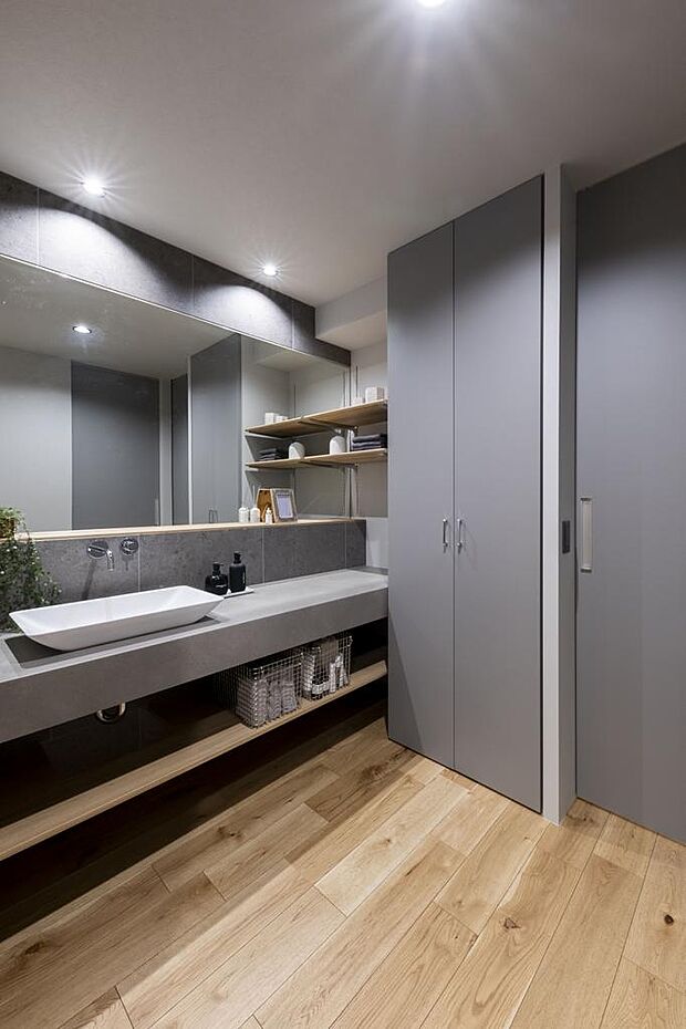 造作の洗面スペース。洗面ボウルの横に広いカウンターがあるので、朝の支度もスムーズです。収納スペースを豊富に設けてあります。