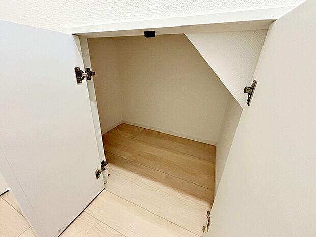 階段下を有効活用した扉付の収納スペース。意外とかさばる掃除用品を収納することも可能