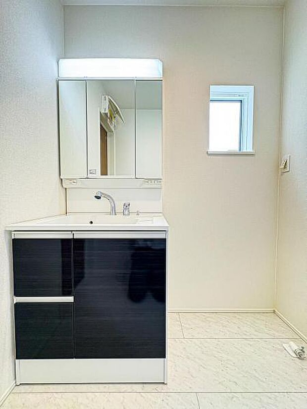 【収納豊富な三面鏡洗面台】左右の鏡を開いて三面鏡としても使える大型の鏡を設置。鏡の裏には、洗面用具などを機能的に収納できるスペースを設けています。