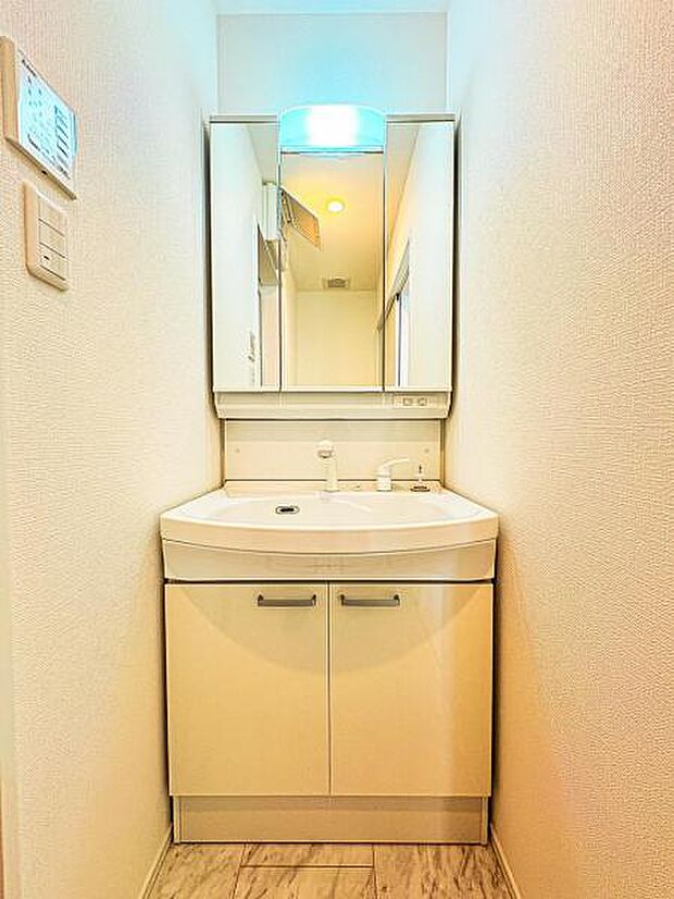 【嬉しい収納豊富な三面鏡洗面台】左右の鏡を開いて三面鏡としても使える大型の鏡を設置。鏡の裏には、洗面用具などを機能的に収納できるスペースを設けています。
