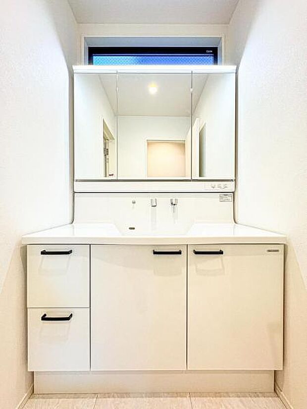 【収納豊富な三面鏡洗面台】左右の鏡を開いて三面鏡としても使える大型の鏡を設置。鏡の裏には、洗面用具などを機能的に収納できるスペースを設けています。