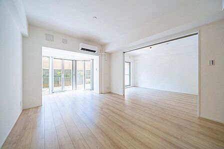 大きな窓からたっぷりと陽光が差し込む明るいリビング。家族が自然と集まり、くつろぎの時間を共有できる心地よい空間です。