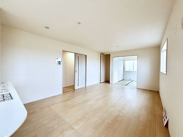 明るい陽光が注ぎ、寛ぎの雰囲気に満たされるリビング・ダイニング。 