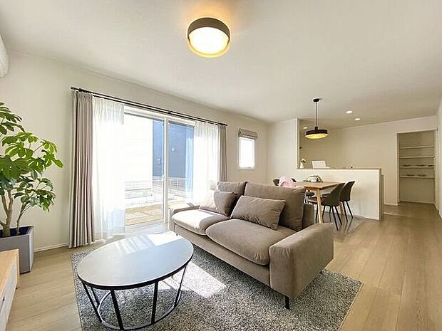 大きな窓が設けられ採光もしっかり取り入れられ、ご家族がゆっくりくつろぐ事ができる明るい温かみのあるリビングです。