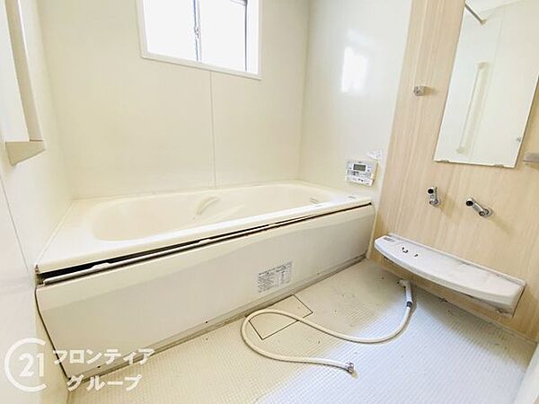 落ち着いた色調で統一された、リラックス感あふれるバスルームです。手すりが設置されており、お子様からご年配の方まで安心して入浴を楽しめます。日々の疲れを癒やすためのゆとりある空間が広がっています