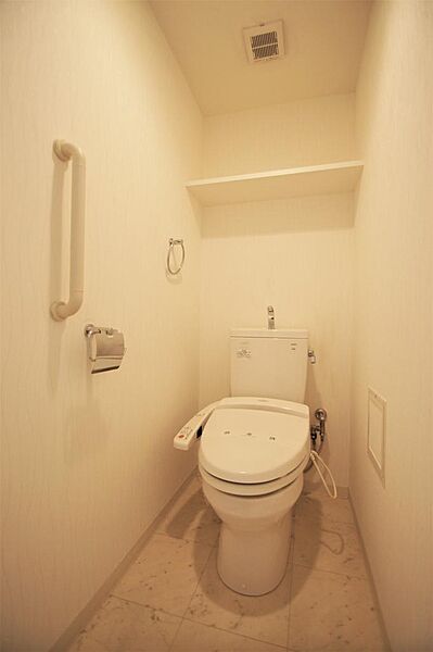 画像16:トイレは温水洗浄機能付きです。上部収納もあります。