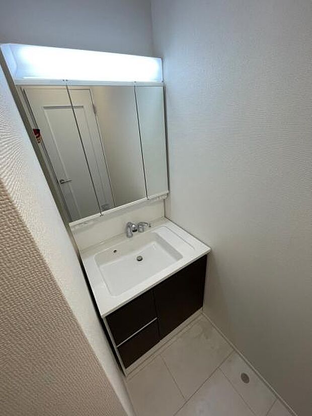 A号棟 人気の三面鏡タイプの洗面台です。鏡の裏にも棚があるので収納豊富です。