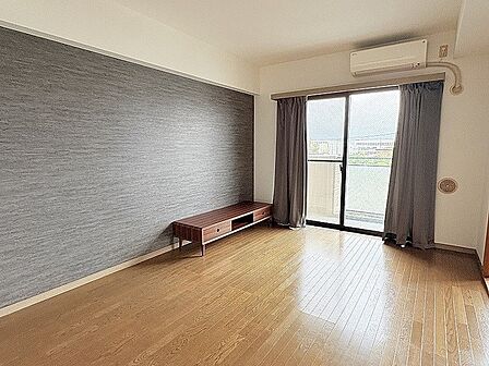 シックな色合いのアクセントクロスが落ち着いた雰囲気を演出する心地よい空間