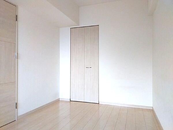 明るい木目調の床と白い壁が、お部屋をすっきりと広く見せます。収納も備え付けで、家具の配置もスムーズです。