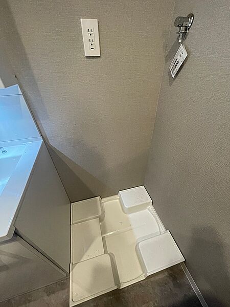 洗面台横に防水パンを設置しており、万が一の水漏れ時も安心です。コンセントも完備し、家電の使用に便利です。