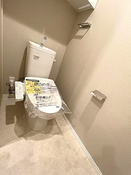 清潔感のある温水洗浄便座付きトイレ。トイレットペーパーホルダーが2つあり、予備のペーパーもすぐに取り替えられます。