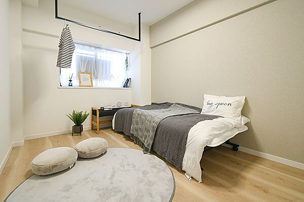 明るい光が差し込むお部屋。窓辺のディスプレイや天井の物干しレールが、日々の暮らしに彩りを添えます。
