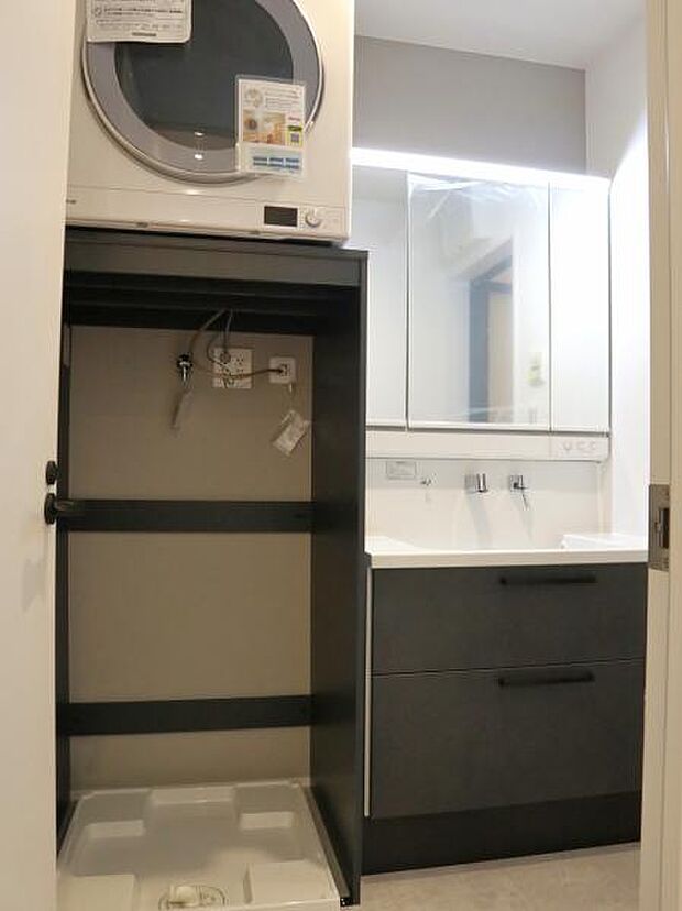 三面鏡の裏は機能的な収納を配置。コンセントも付いているため電動シェーバーや電動歯ブラシも収納できます。