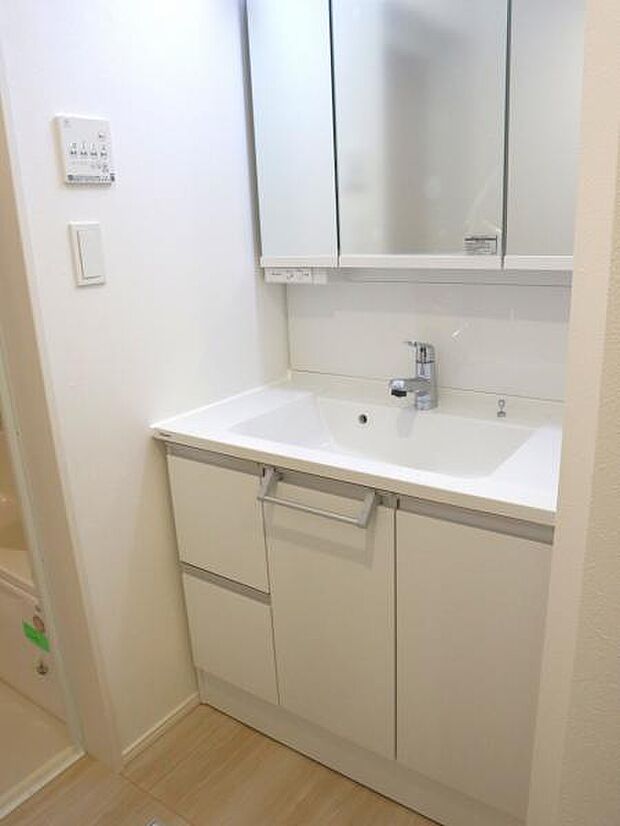 三面鏡の裏は機能的な収納を配置。コンセントも付いているため電動シェーバーや電動歯ブラシも収納できます。