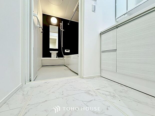 「清潔な印象の洗面室」明るく清潔感のある色調で纏められた洗面室は、機能性に富んだ三面鏡と使い勝手の良い収納を完備した洗面台を設置。洗濯機置場も完備し、大変充実しております。