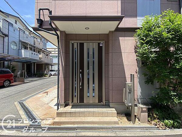 シンプルでスタイリッシュな玄関。広々としたアプローチは、開放感を感じさせ、家族やゲストを歓迎する空間です。