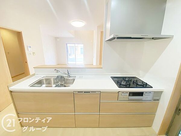 清潔感あふれるホワイトのシステムキッチンは、広々としたシンクと調理スペースが確保されています。家族の様子を見守りながら料理ができる対面式で、毎日の家事時間がより快適で豊かなものに変わります