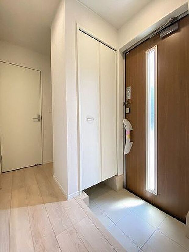 窓から光の入る明るい玄関で、家族やお客様をお迎えできます。