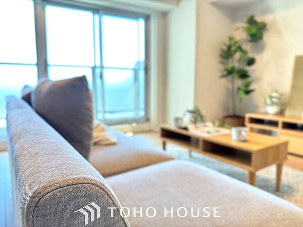 【Decorative lighting】　上質に仕上げられた室内。オフ・ホワイトの壁を背にした観葉植物の葉をそっと置かれたインテリア・ライトが照らし出しています。少しお洒落な暮らしをしてみませんか。
