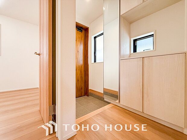 明るくコントラストのある、開放感と清潔感を兼ね備えた玄関。