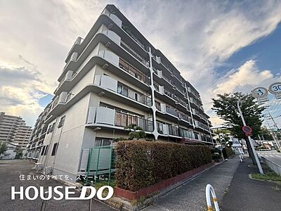 外観:ゆるやかに弧を描く白い手すりのバルコニーが連なる、重厚な外観のマンションです。生垣が目隠しになり、落ち着いた佇まいです。 外観:ゆるやかに弧を描く白い手すりのバルコニーが連なる、重厚な外観のマンションです。生垣が目隠しになり、落ち着いた佇まいです。