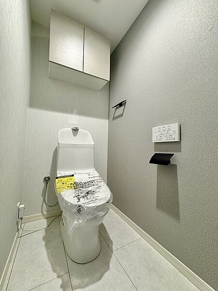【トイレ】温水洗浄便座付で、毎日快適にお使いいただけるトイレです。掃除用品やトイレットペーパーの保管に役立つ収納が備わっています。