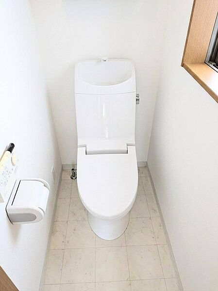 小窓から自然光が差し込む、温水洗浄便座付きのすっきりと明るいレストルーム。