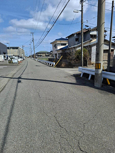 見通しの良い直線道路が続き、車の運転もゆったり。周辺は住宅と店舗が程よく混在しています。