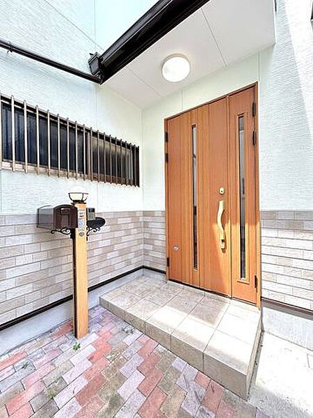 【玄関】玄関の写真です。玄関ポーチは屋根つきです。ちょっとそこまでの時に便利な折りたたみ自転車も玄関先に置けますよ。