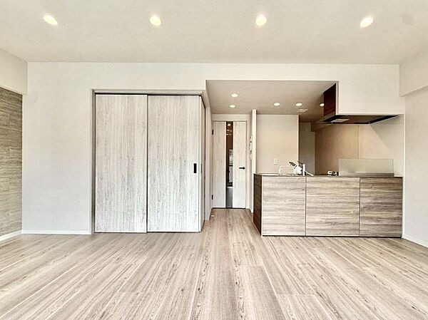 床や建具、キッチンを木目調でそろえた、統一感のあるリビングダイニング。ダウンライトが空間をすっきりと照らします。対面式キッチンから室内を見渡せるため、料理中もご家族との会話を楽しめる住空間です。