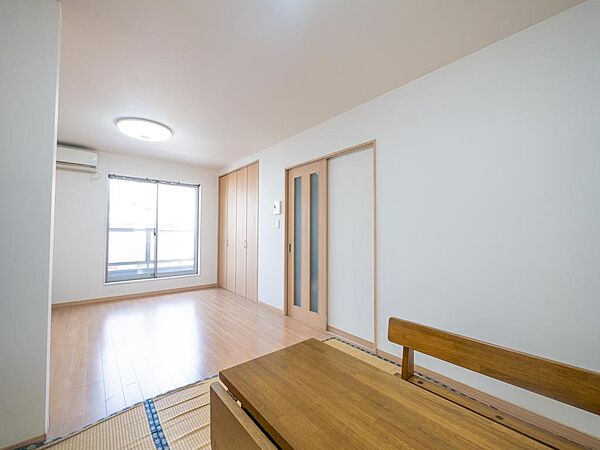 大きな開口部から明るい陽光が差し込む開放的なリビング空間。家族団らんの時間を心地よく演出します。