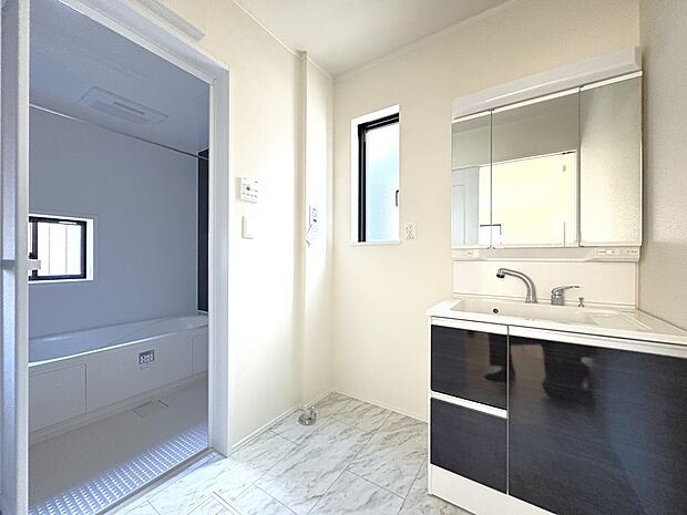 【洗面室】豊富な収納を備えた洗面台・窓のある明るい洗面室