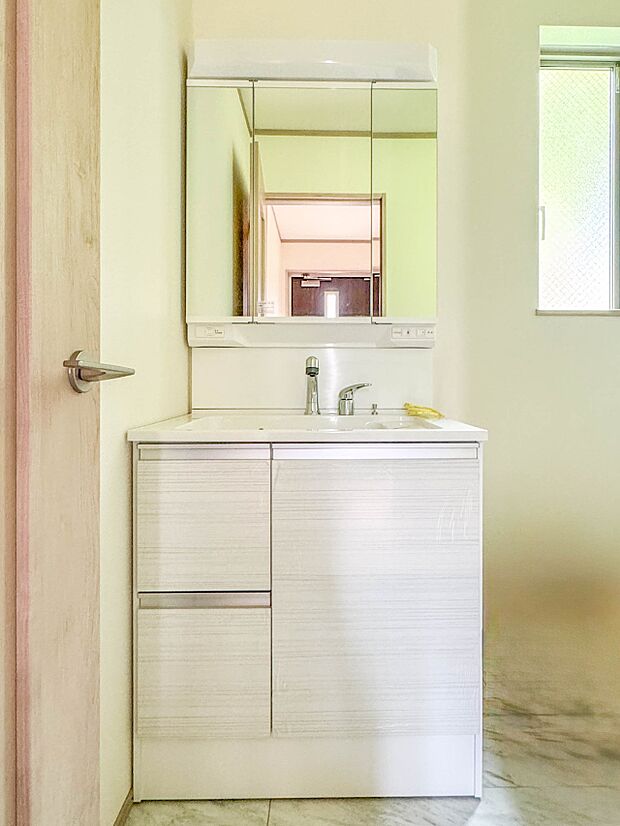 【洗面台】大きく見やすい三面鏡で清潔感ある洗面台は、身だしなみチェックや肌のお手入れに最適です。何かと物が増える場所だからこそ、スッキリと見映えの良い空間に拵えました。