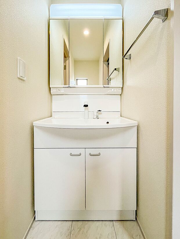 【洗面所】大きく見やすい三面鏡で清潔感ある洗面台は、身だしなみチェックや肌のお手入れに最適です。何かと物が増える場所だからこそ、スッキリと見映えの良い空間に拵えました。