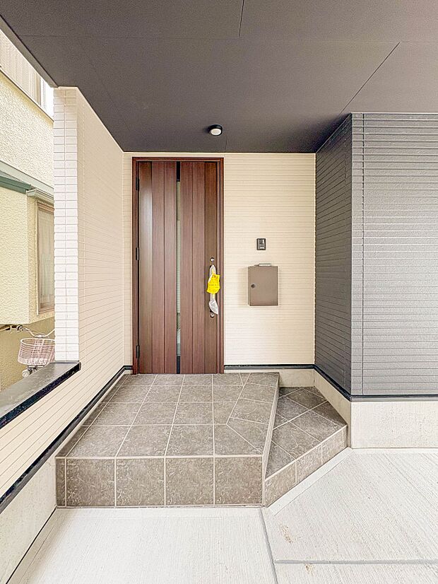 【玄関】玄関へ向かうまでのアプローチに漂う上質が期待感をもたせます。玄関は建物の顔。落着きを醸し出した自己主張が心に訴えてきます。