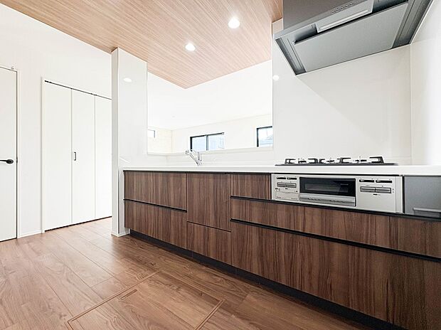 【キッチン】三口コンロで料理の幅を拡げてくれる使いやすいシステムキッチンを採用。洗い場も大きいので野菜や食器を洗ったりする際にも捗り、奥様の強い味方となってくれるはずです。