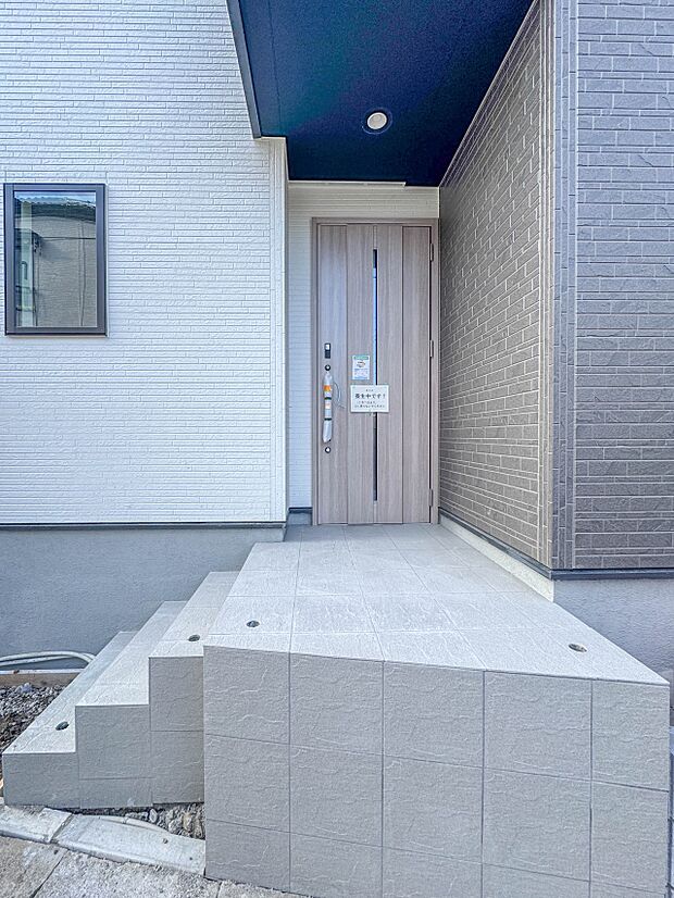 【玄関】玄関へ向かうまでのアプローチに漂う上質が期待感をもたせます。玄関は建物の顔。落着きを醸し出した自己主張が心に訴えてきます。