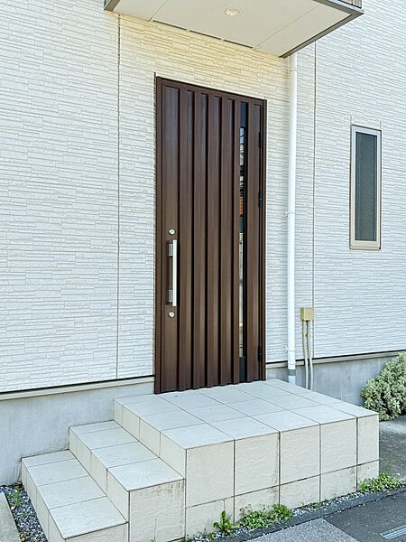 【玄関】玄関へ向かうまでのアプローチに漂う上質が期待感をもたせます。玄関は建物の顔。落着きを醸し出した自己主張が心に訴えてきます。