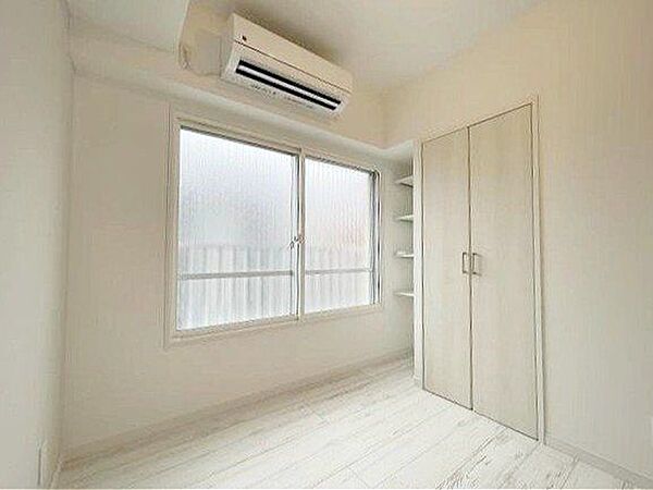 やさしい陽射しが差し込む寝室は、心地よい眠りへと誘う癒しの空間。木目調の床と白を基調とした壁が、清潔感とやわらかな印象を与え、毎日の疲れをそっと包み込みます。