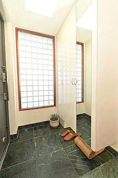 採光良好な明るい玄関。格子窓から柔らかな光が入り、落ち着いた雰囲気。シューズボックスも完備で、すっきり整理できます。※CG加工しております。