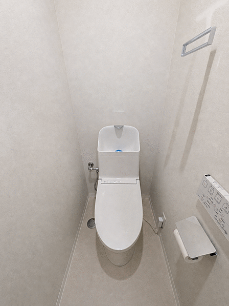 トイレ 温水洗浄便座付きのトイレです。タオル掛けも備わり、明るい色合いの内装で清潔感があります。お子様も無理なく使えるゆとりある広さが確保されています。
