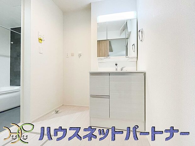 三面鏡洗面化粧台。ミラーを手前に引けば、楽な姿勢で髭剃りやメイクができます。合わせ鏡にすればヘアスタイルのチェックもラクラク。洗面化粧台のミラー裏にはたっぷり入る収納スペースを設けています。　