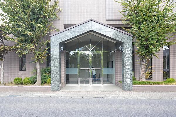 【エントランス】　屋根付きで雨の日も安心のエントランス。植栽も丁寧に手入れされています。