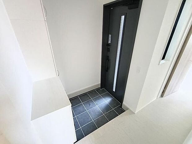 玄関です。建物の中心に配置されており、LDKや各居室へのスムーズな動線の入り口となっています。