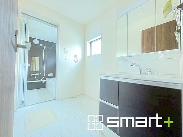 ~明るい洗面スペース~ ・窓から明るい陽が入り、気持ちよく朝の支度ができますね。 ・使い勝手の良い三面鏡タイプのシャワー付き洗面化粧台。鏡の裏に収納があるので洗面台周りもスッキリ。